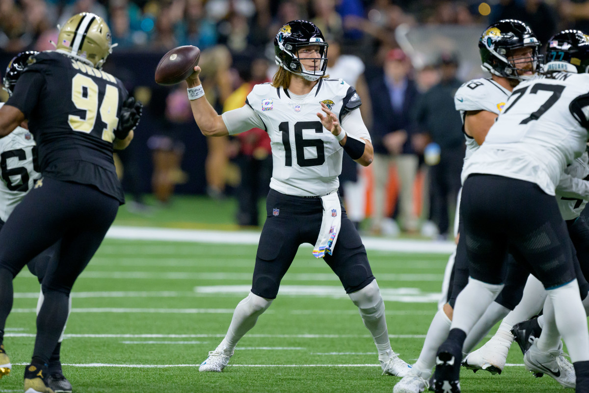 Trevor Lawrence brings his arm back to throw the ball